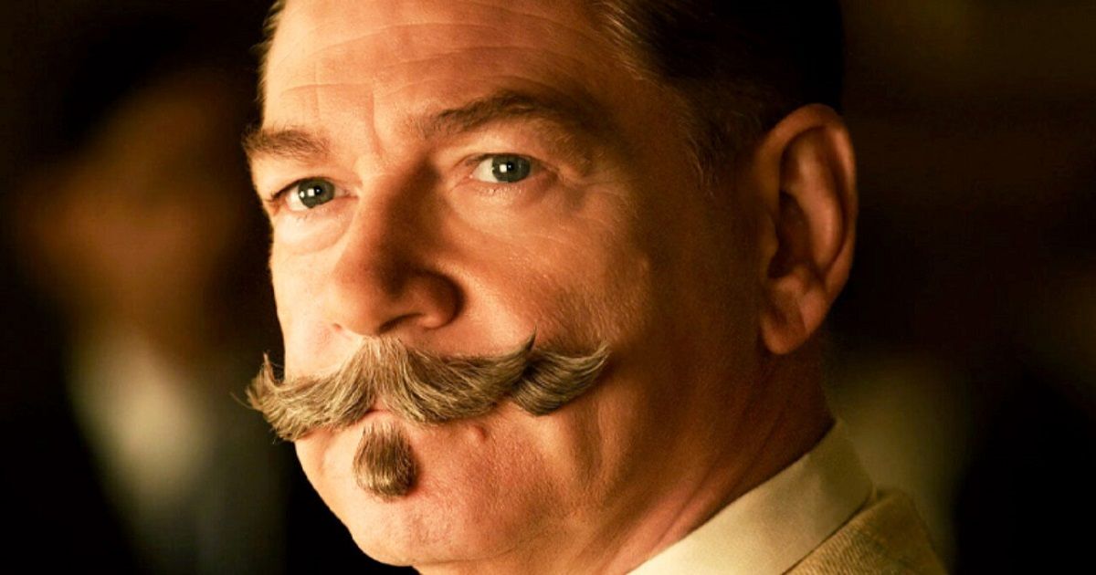 Kenneth Branagh as Poirot, with his long mustache, wearing a suit and looking at something off-screen.