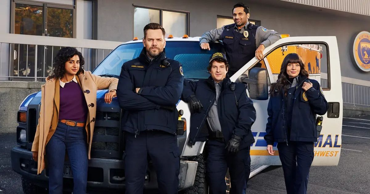The cast of Animal Control poses by a squad car
