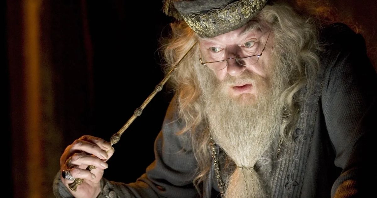 Michael Gambon as Dumbledore with his wand to his temple