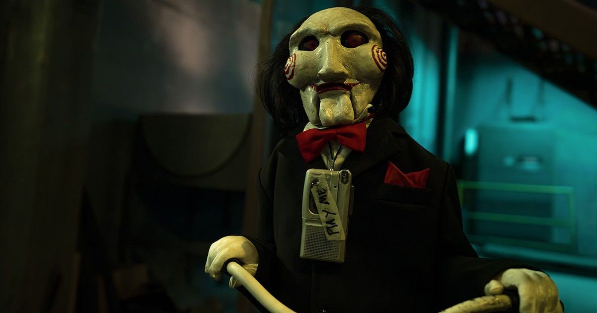The puppet from Saw rides his bike with a tape recorder on his neck in Saw X.