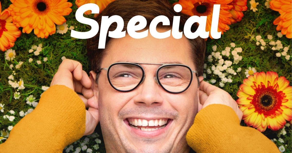 Ryan O'Connell smiling in front of flowers for Special (Netflix) 