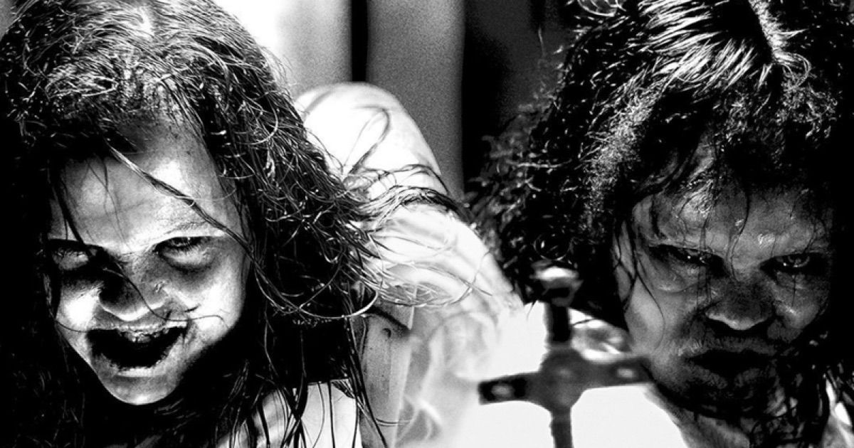 Two possessed girls look at a cross and smile in The Exorcist: Believer.