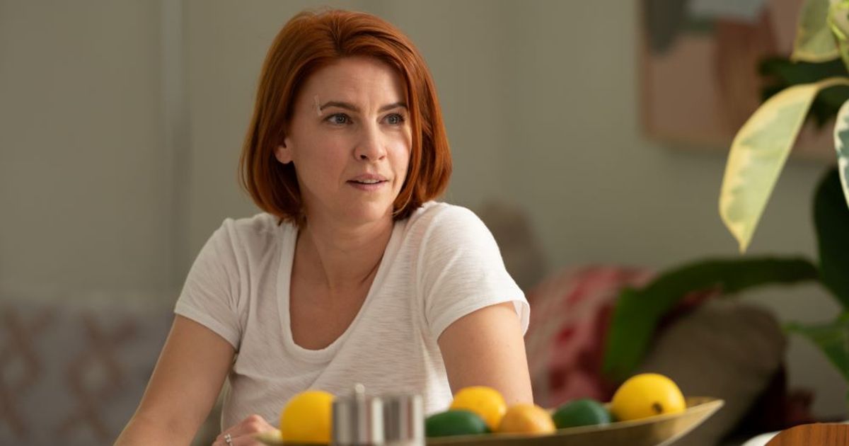 Anne sits at the dinner table in Workin' Moms