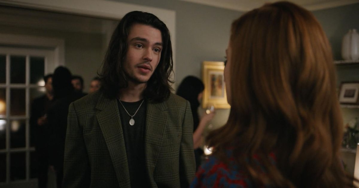 Aiden wears a gray blazer in Zoey's Extraordinary Playlist