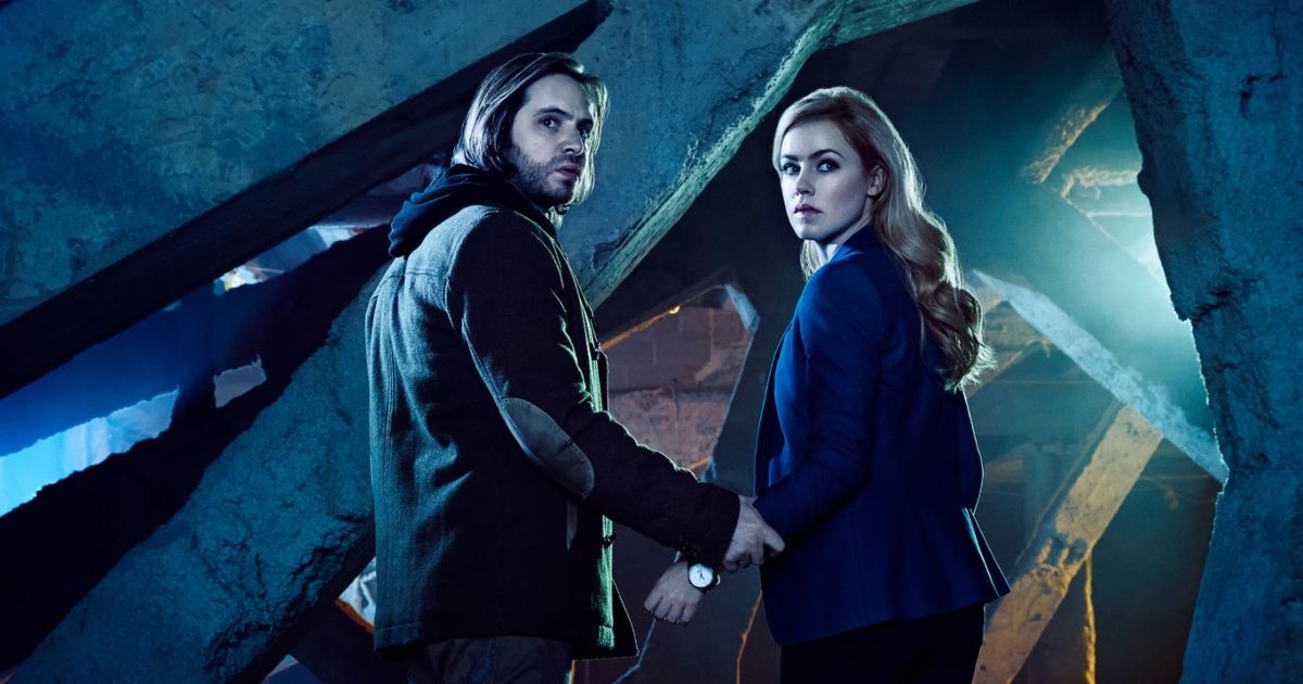 Two characters holding hands in 12 Monkeys