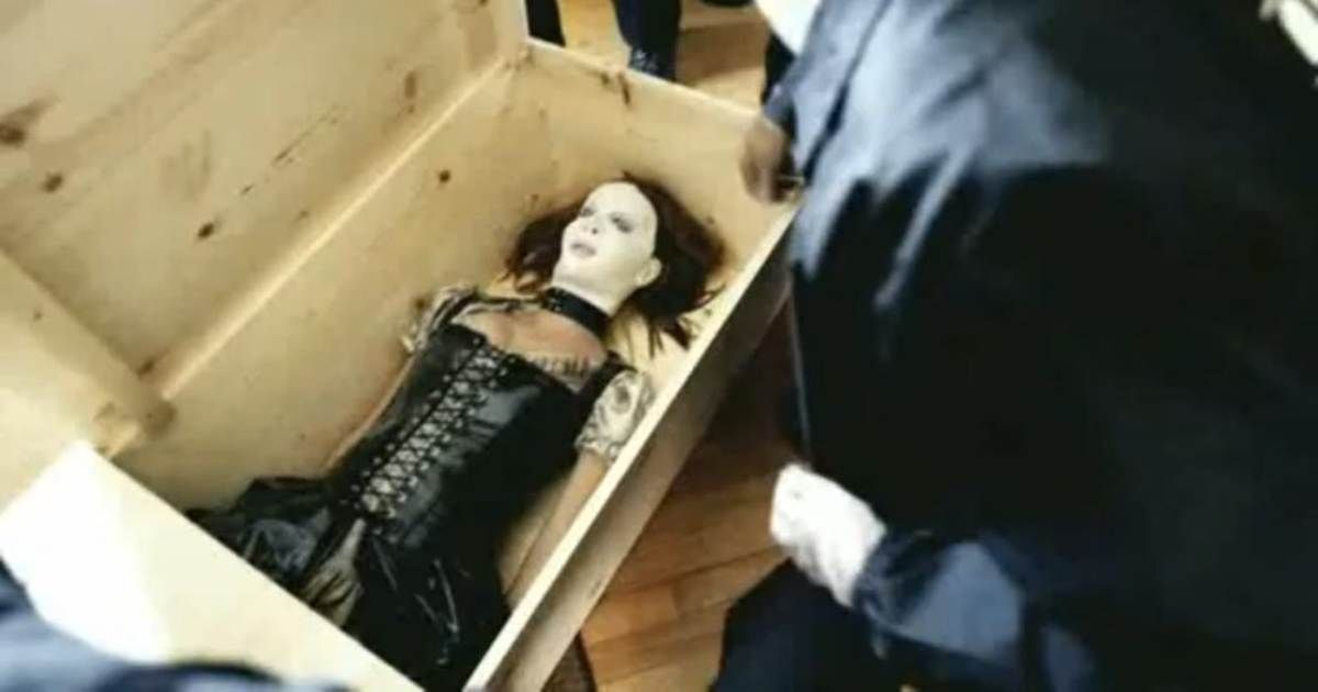 A masked woman lies in a wooden coffin in The Poughkeepsie Tapes