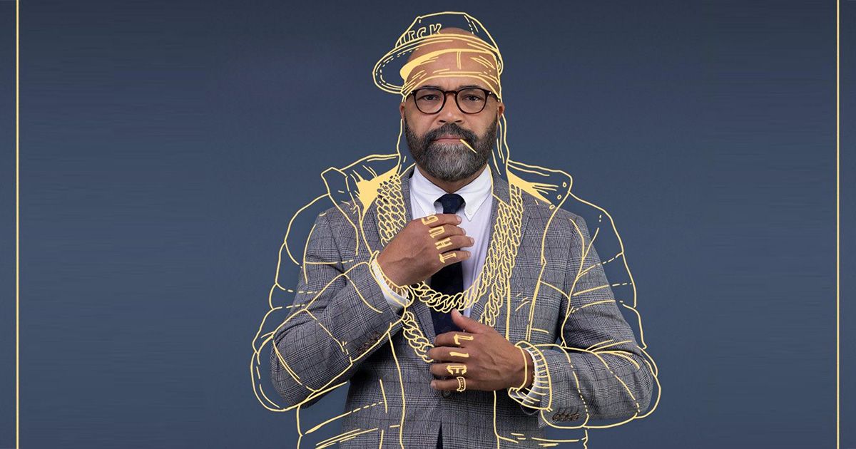 Jeffrey Wright wearing a suit with an outline of a puffer coat, tattoos, rings, and a hat on for the American Fiction poster.