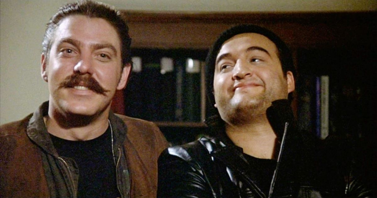 Bruce McGill & John Belushi with a bookcase in the background in Animal House