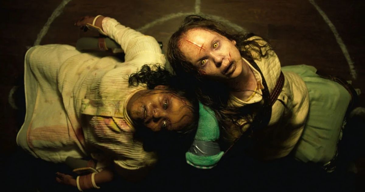 The Exorcist Believer girls look up as they are possessed, sitting in chairs back to back