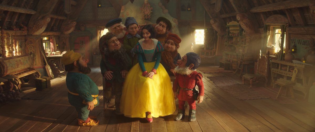 Rachel Zegler as Snow White in Disney's live-action remake. She is in her iconic dress inside a small cottage home.