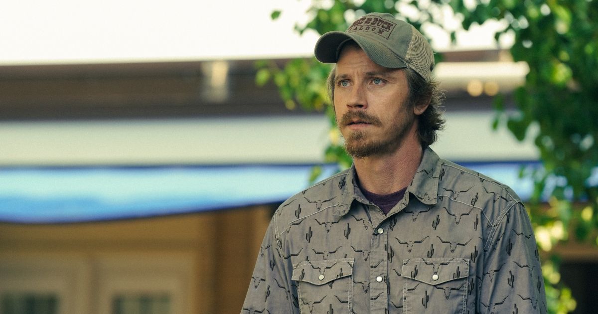 Garrett Hedlund in a collared shirt and hat in Tulsa King