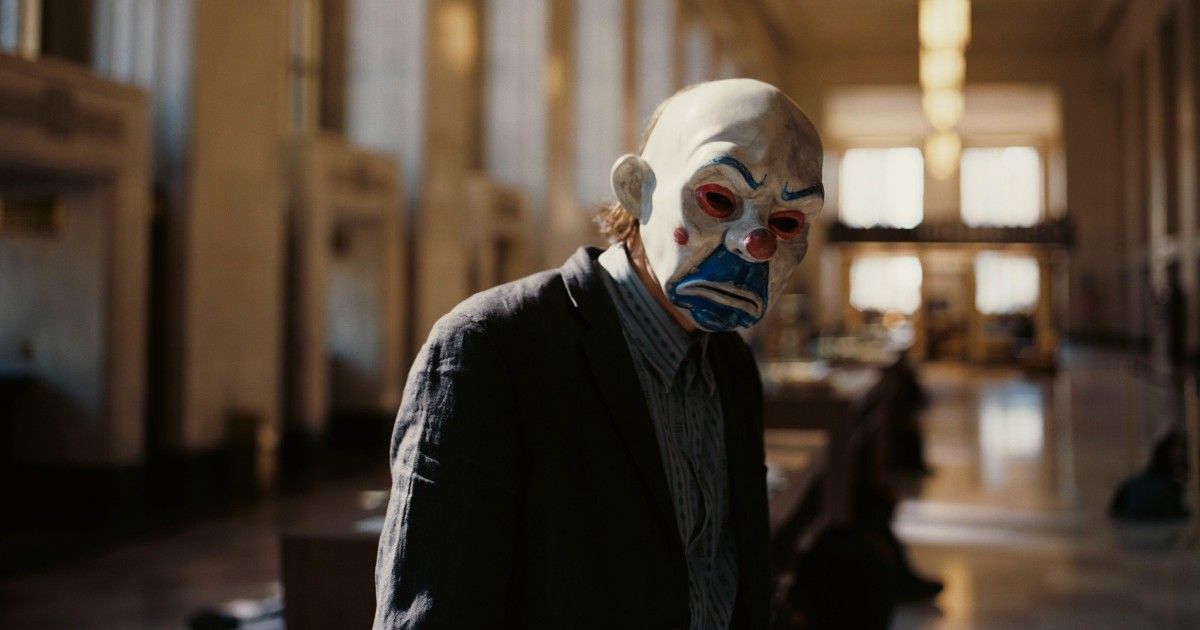 Man in clown mask during heist scene from The Dark Knight