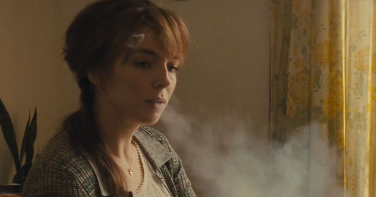 Jodie Comer letting out an exhale of smoke in The Bikeriders