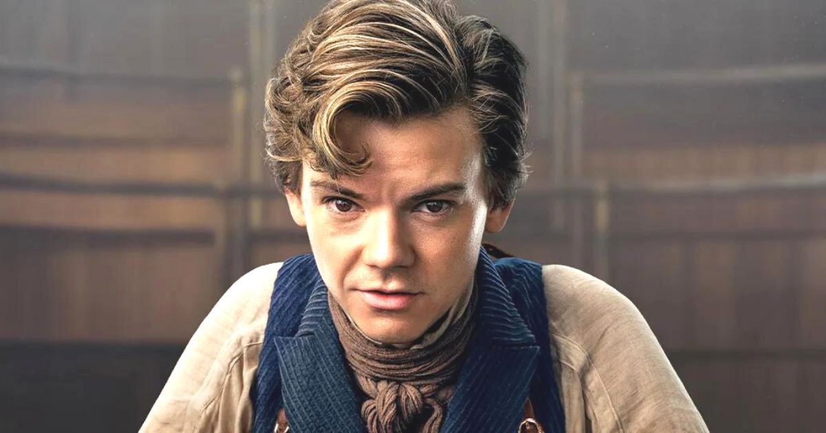 Thomas Brodie-Sangster looks at the camera in old fashioned clothes in The Artful Dodger