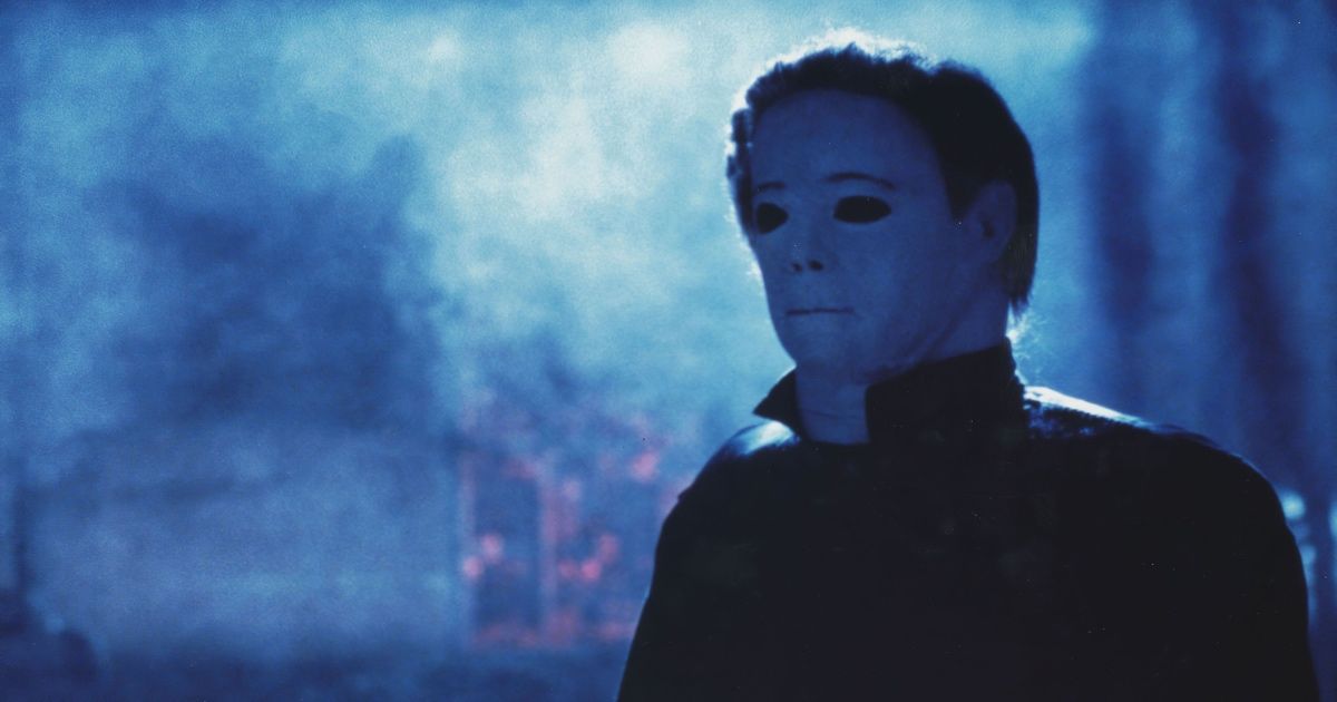 Michael Myers wearing his iconic jumpsuit and mask with a thick layer of fog behind him in Halloween 4: The Return of Michael Myers