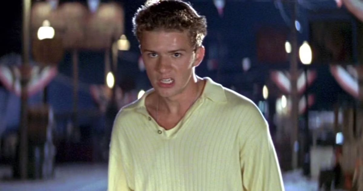 Ryan Phillippe wearing a yellow collared shirt on a dock in I Know What You Did Last Summer
