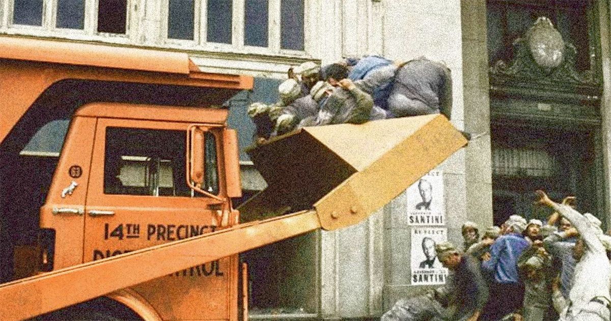 A garbage truck picking up trash with people inside in Soylent Green