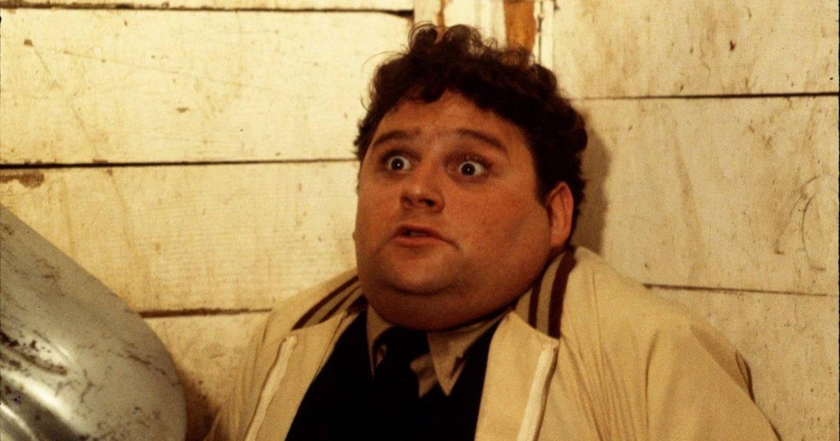 Stephen Furst backed against a wall with wide eyes in Animal House