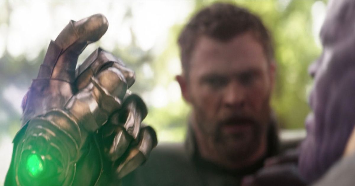 Thanos about to snap his fingers with the infinity gauntlet as Thor looks in desperation in Avengers: Infinity War.