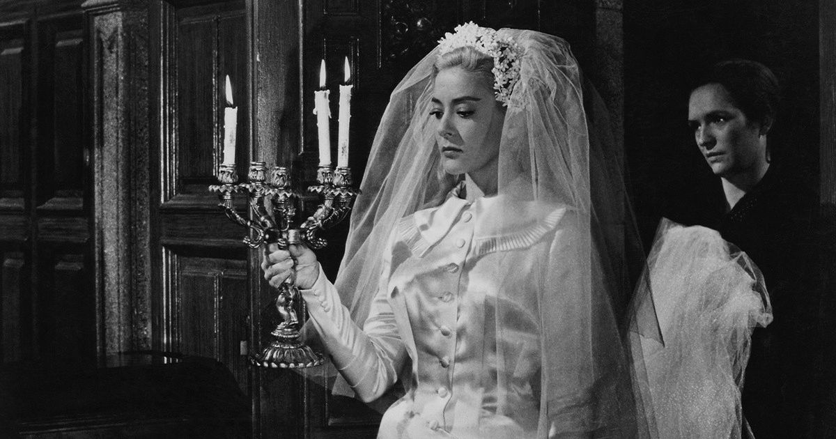 A black-and-white shot of Silvia Pinal as Viridiana, holding a candle (1961) 