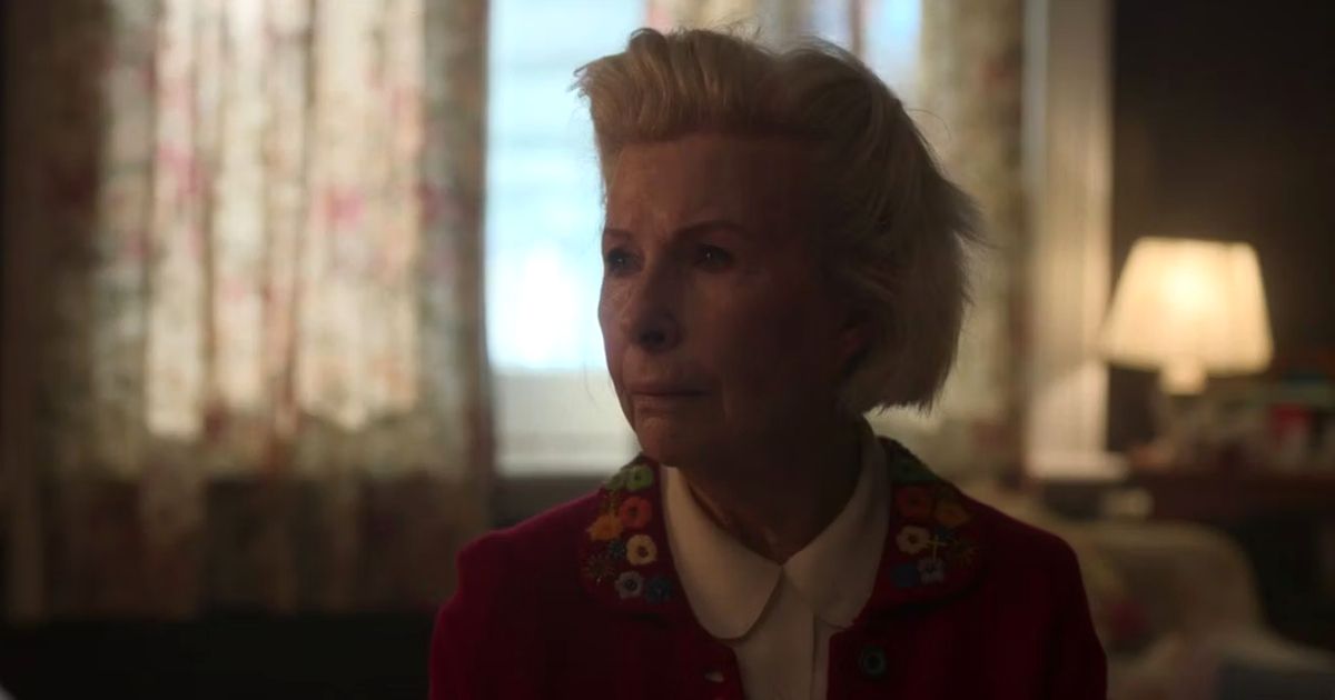 Gwen sits by a window in Wolf Like Me