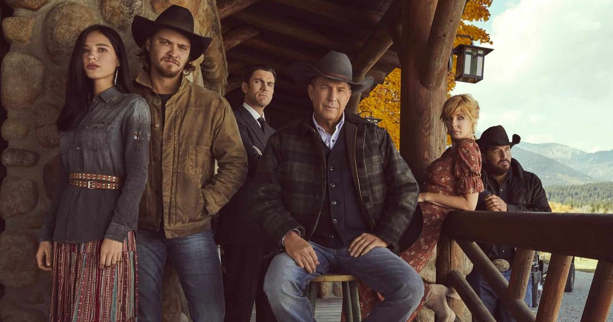 The cast of Yellowstone poses on a porch