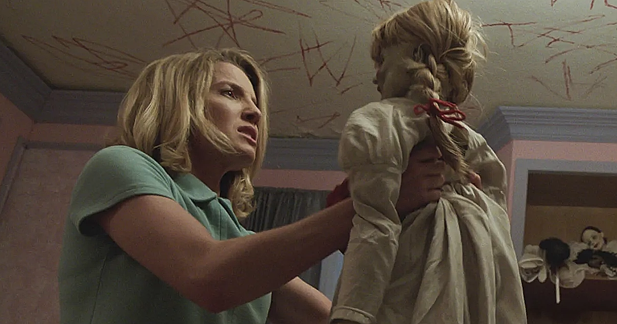 Annabelle Wallis holding Annabelle, the doll, in the movie called Annabelle.