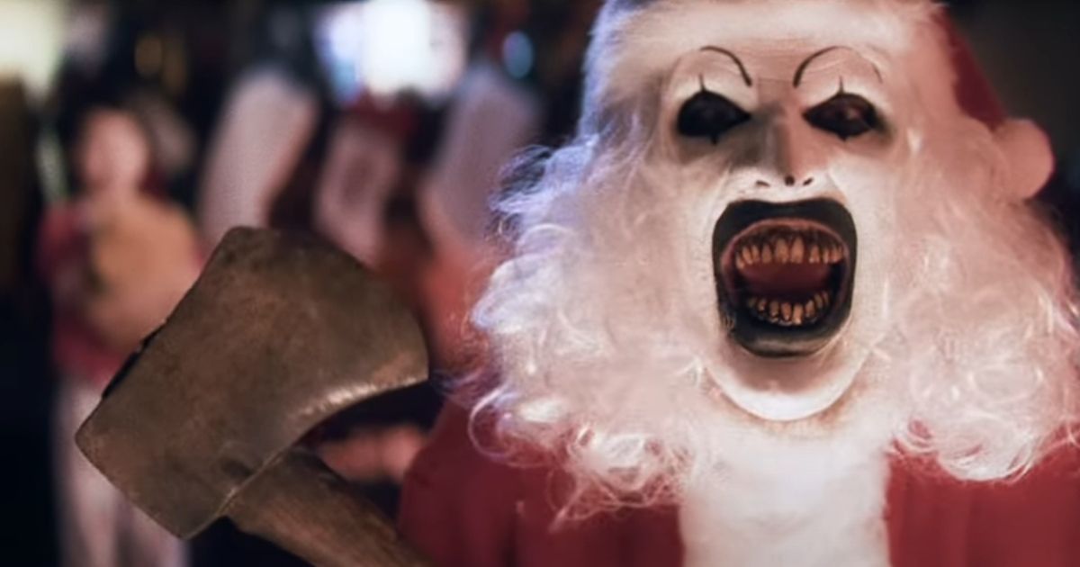 Art the Clown dressed as Santa Claus holding an ax in Terrifier 3