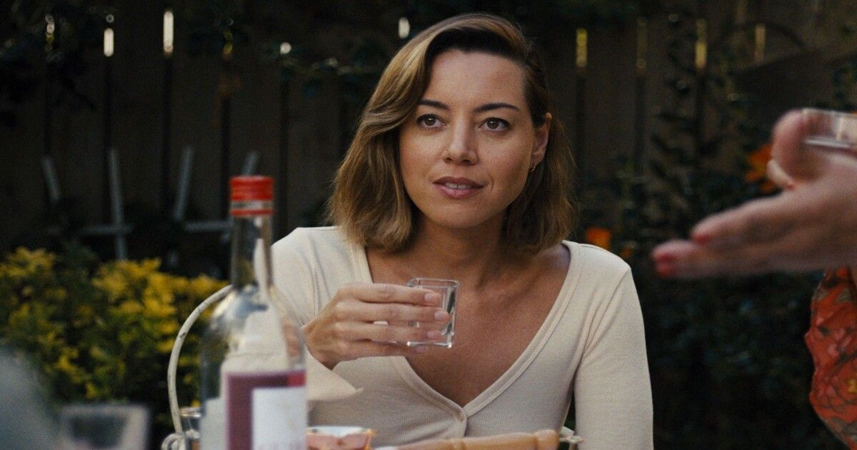 Aubrey Plaza in Emily the Criminal holding a glass.