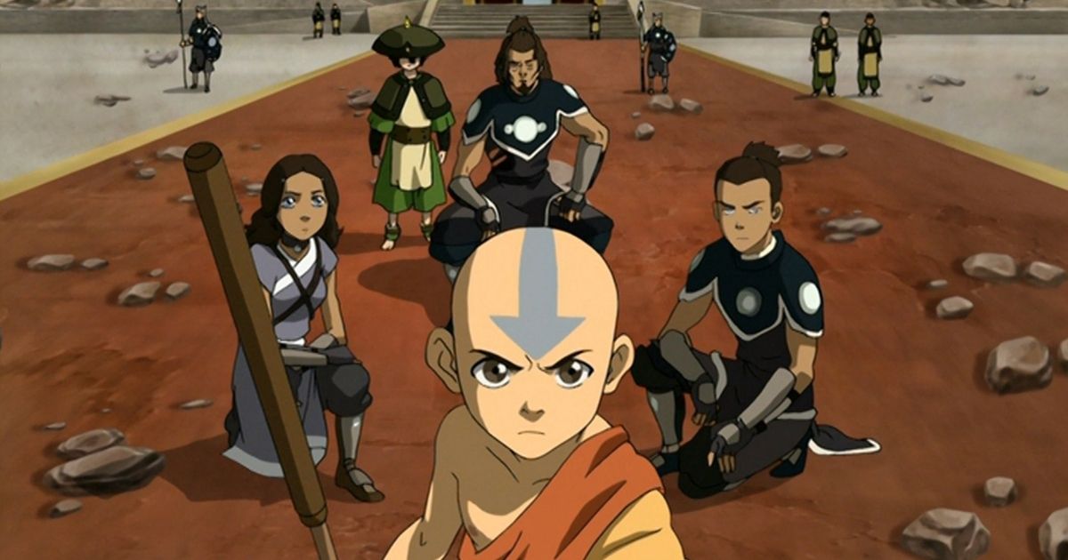 Avatar Aang and his friends kneel on the battleground, debris everywhere.