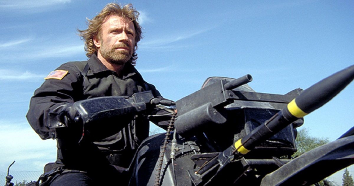 Chuck Norris atop some sort of vehicle that appears to contain missiles.