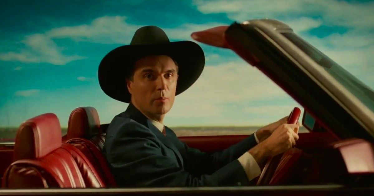 David Byrne driving a car in True Stories.