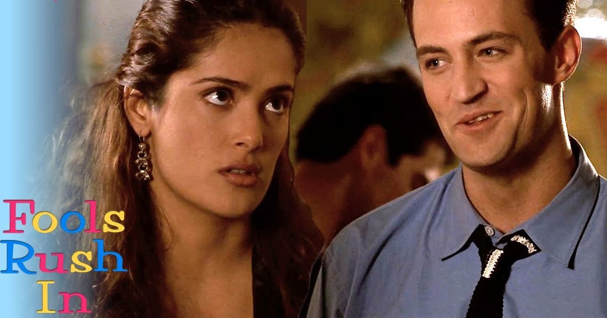 Matthew Perry wearing a blue collard shirt and black tie with Salma Hayek in Fools Rush In 