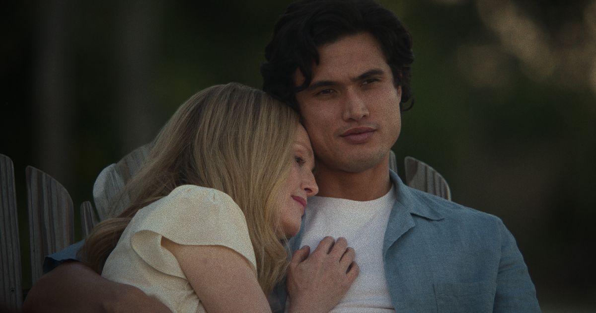 Julianne Moore as Gracie and Charles Melton as Joe, cuddling on a chair in May December