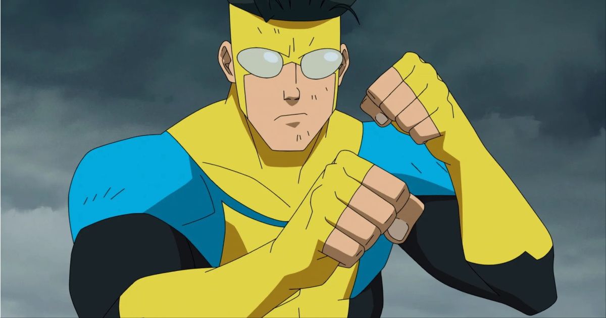 Mark Grayson as Invincible in his yellow, black, and blue suit with his fists raised preparing to fight during a cloudy day in Invincible.