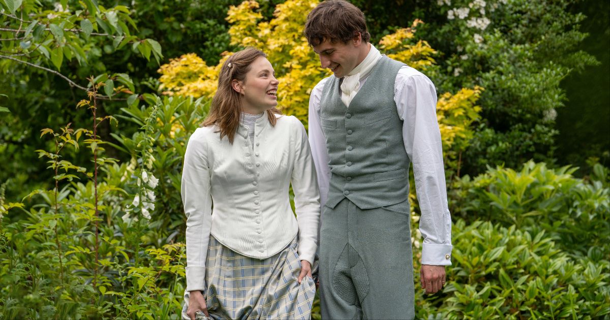 Guy Remmers as Theo and Kristine Froseth as Nan dressed in formal clothing taking a stroll outside in The Buccaneers