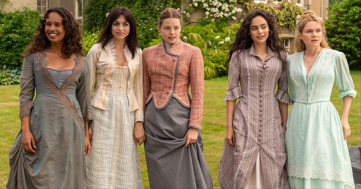 The cast of The Buccaneers, including Kristine Froseth as Nan St. George, Alisha Boe as Conchitta, Josie Totah as Mabel, Aubri Ibrag as Lizzy wearing elegant dresses standing in a courtyard.