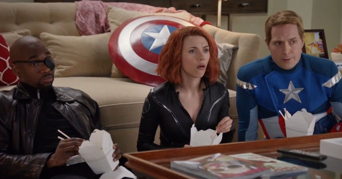 Black Widow, Nick Fury, and Captain America sit around a coffee table, eating Chinese take-out.
