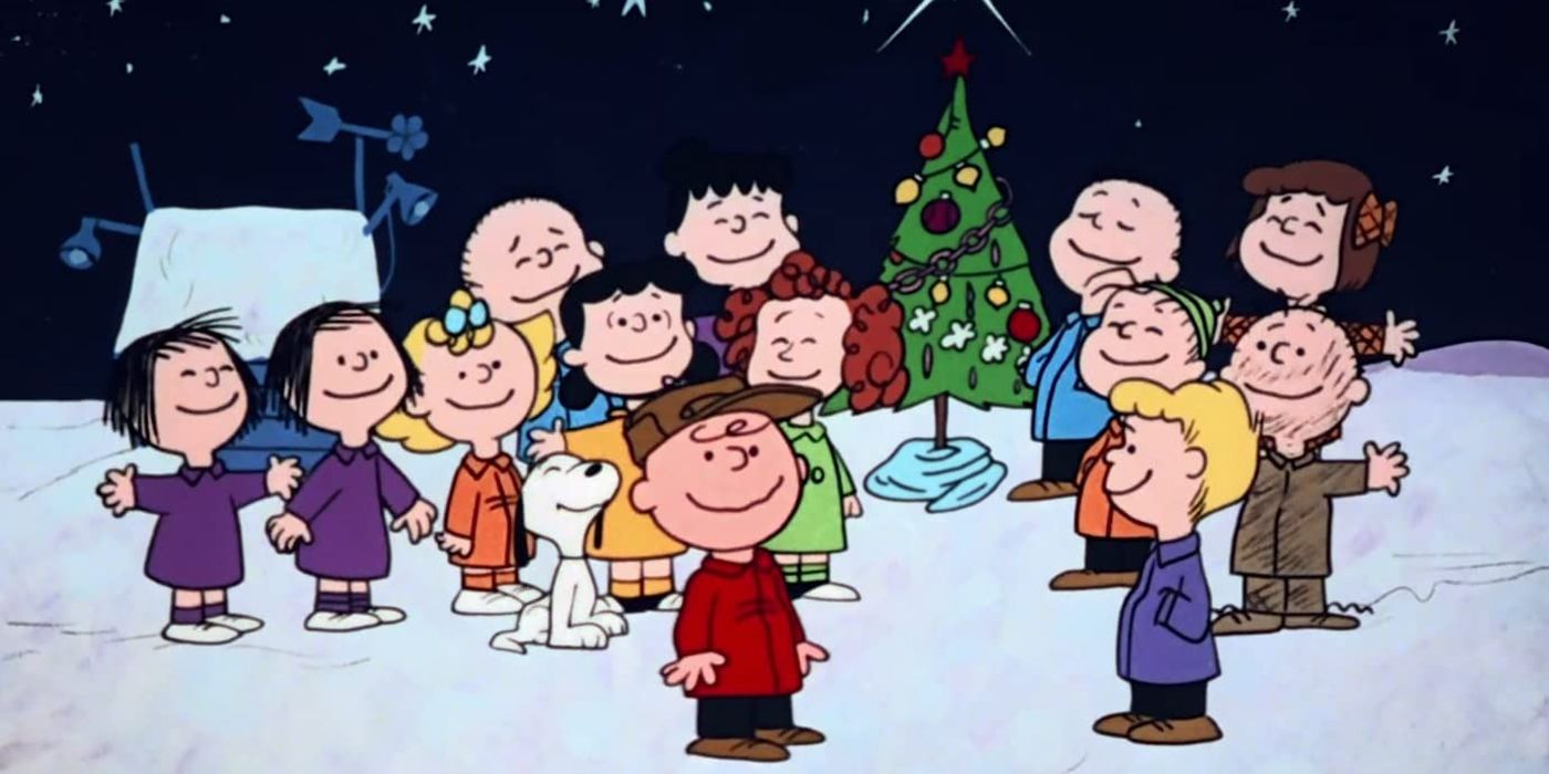 All the kids from A Charlie Brown Christmas singing in the snow around a Christmas tree.