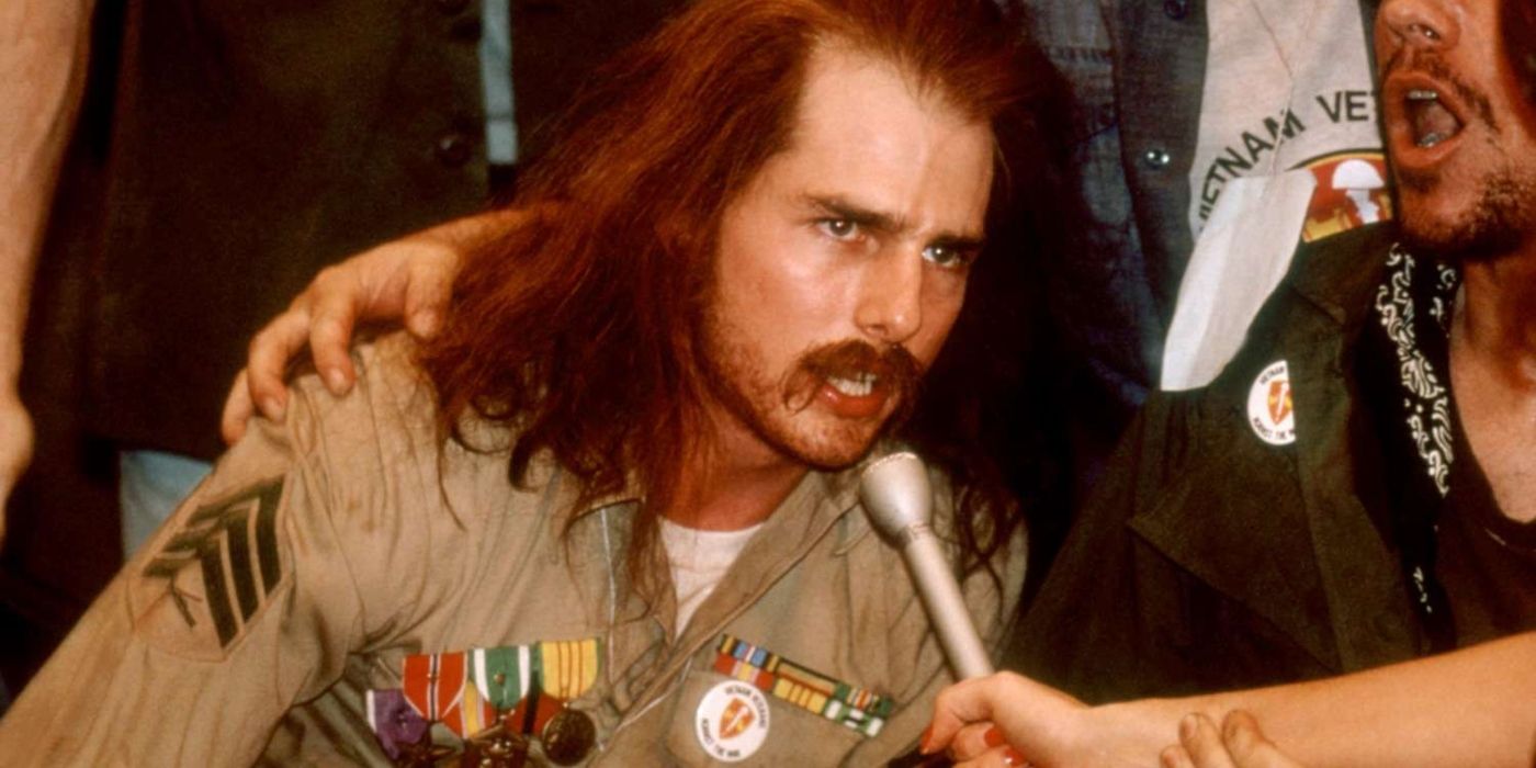 Tom Cruise as Ron Kovic speaking into a microphone in Born on the Fourth of July