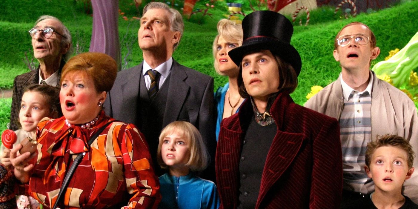 Willy Wonka e seus convidados olham perplexos.