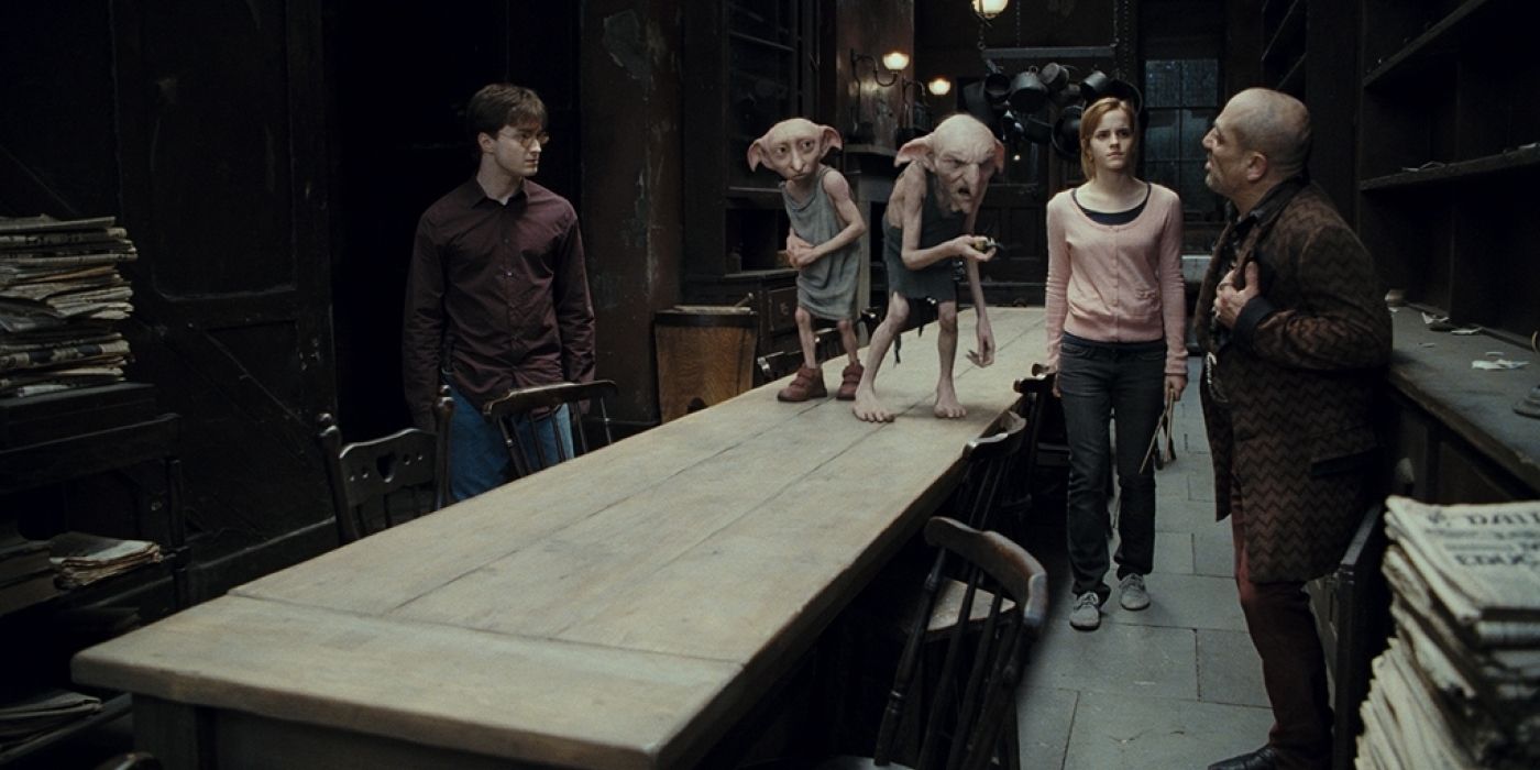 Harry Potter and the Deathly Hallows Part 1 Daniel Radcliffe as Harry, Dobby, Kreacher, Emma Watson as Hermione, and Andy Linden as Mundungus Fletcher discussing a Horcrux