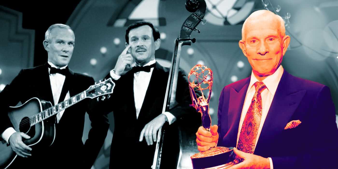 Dick and Tom Smothers wearing tuxedos on stage with a guitar in The Smothers Brothers Comedy Hour and holding up an award