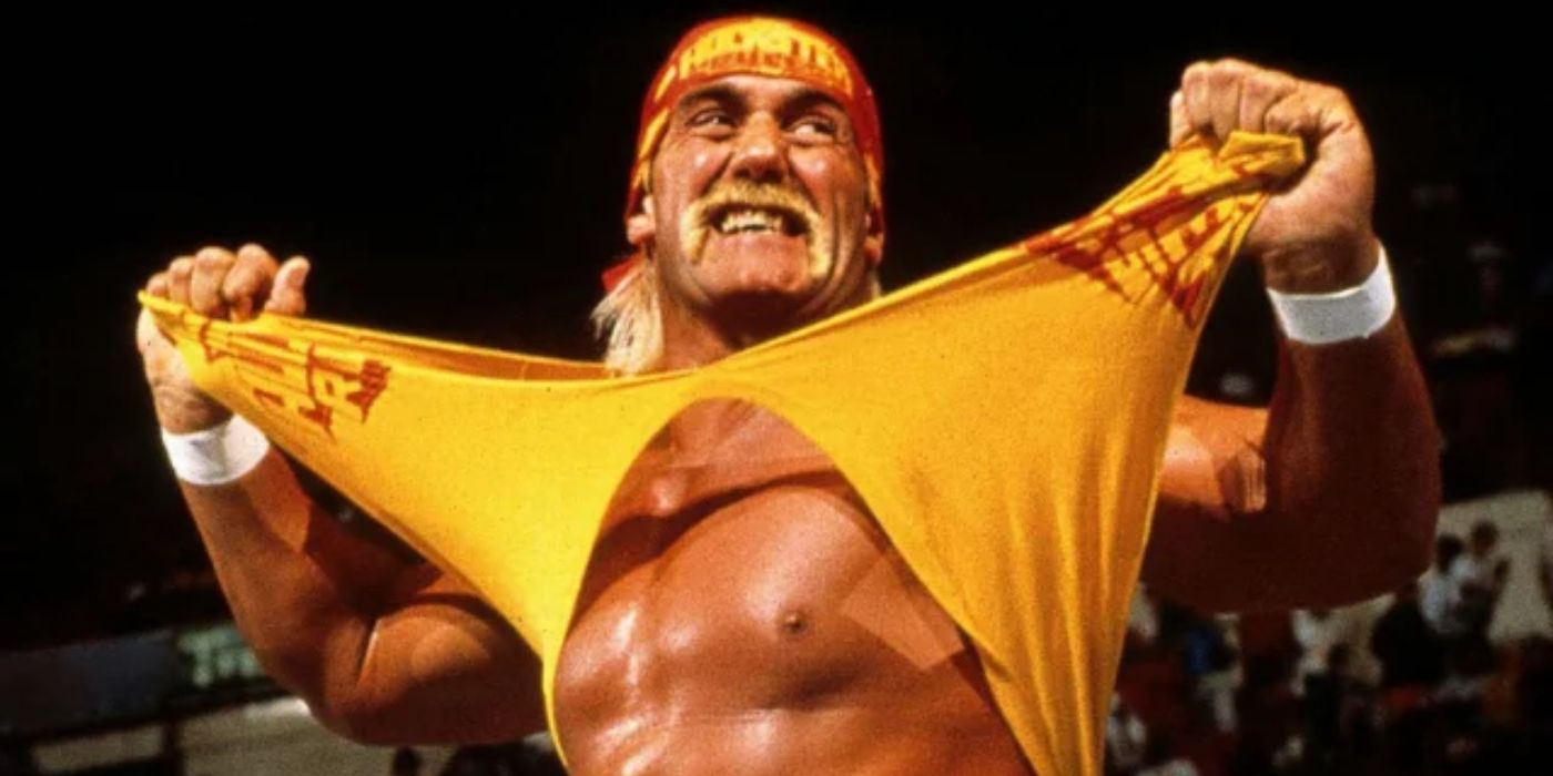 Hulk Hogan tearing off his yellow tank top and smiling at the crowd during a WWF match
