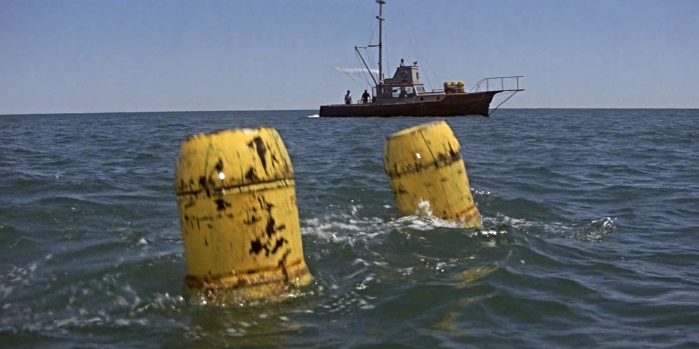 Jaws the two yellow barrels attached to the shark on the surface of the water near the boat