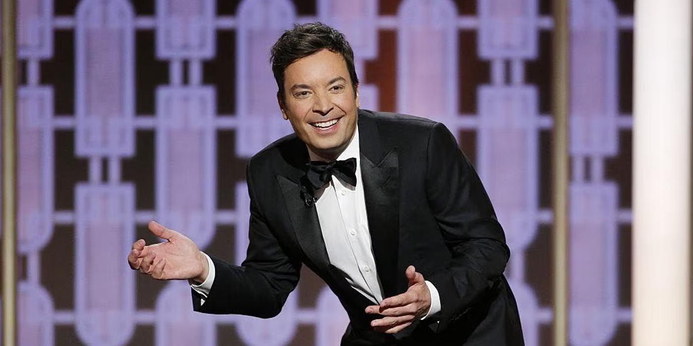 Jimmy Fallon in a tuxedo laughing while hosting the Golden Globes