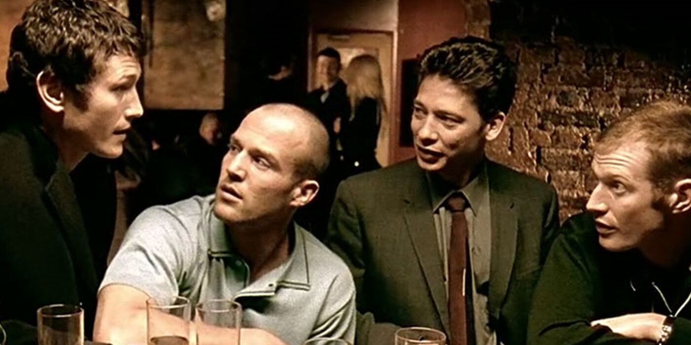Four men having an intense conversation over drinks at a pub