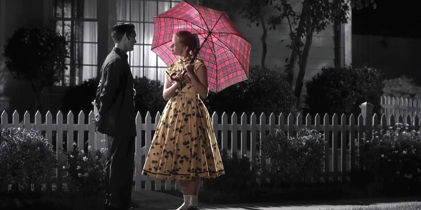 a girl holding a color umbrella in front of tobey maguire in pleasantville