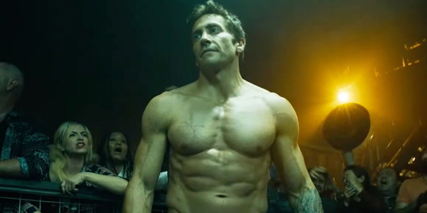 Jake Gyllenhaal with his shirt off, and a crowd of people behind him in Road House 2024