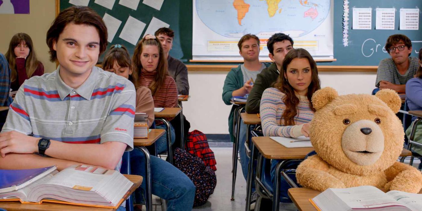 Max Burkholder as John Bennett and Seth MacFarlane as Ted sitting in class with textbooks in front of them in Ted.